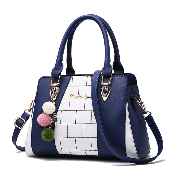 Two-tone handbag with pompom charm