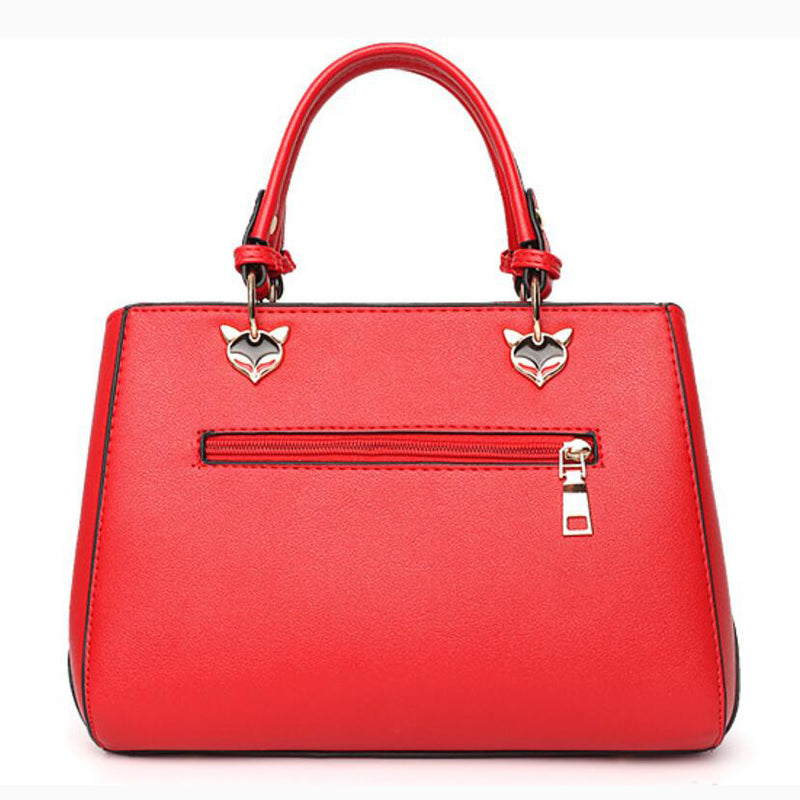 Colorblock handbag with pom-pom charm