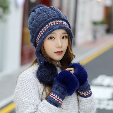 Woman in an ear flap beanie with pompom
