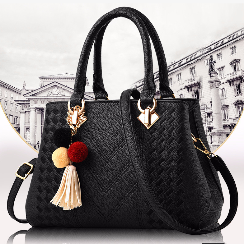 Embossed handbag with pompom charm