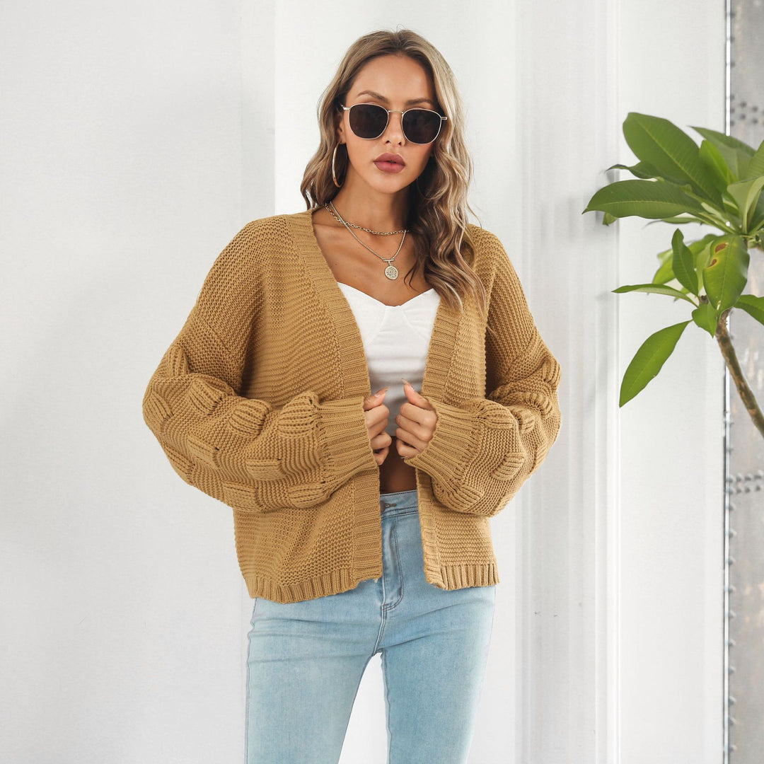 Woman in chunky cable knit puff sleeve cardigan